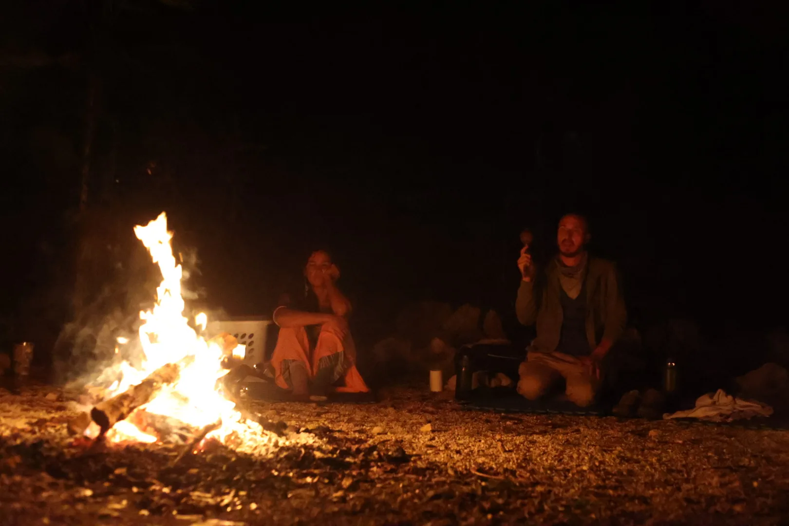 Two people around the sacred fire during a Wixárika ceremony